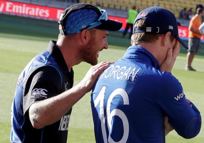New Zealand's captain Brendon McCullum touches England's captain Eoin Morgan on the shoulder after their Cricket World Cup match at Wellington Stadium in Wellington