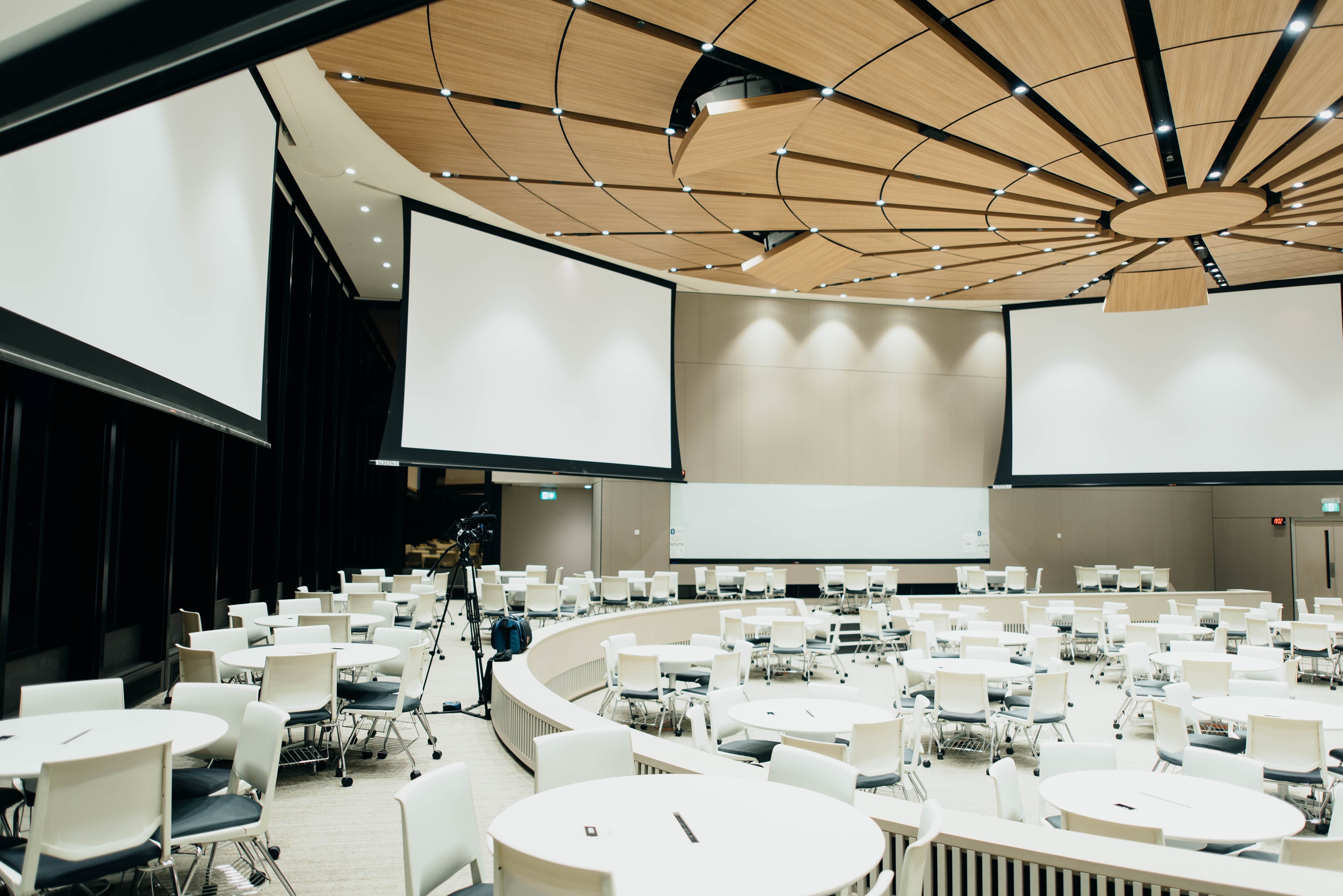 Empty room with white table, chairs and screens